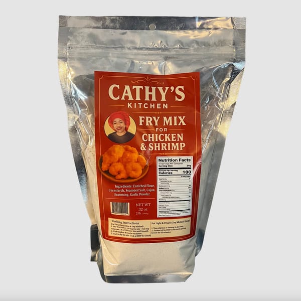 A Cathy's Kitchen Fry Mix bag for chicken and shrimp, featuring a woman and fried food.